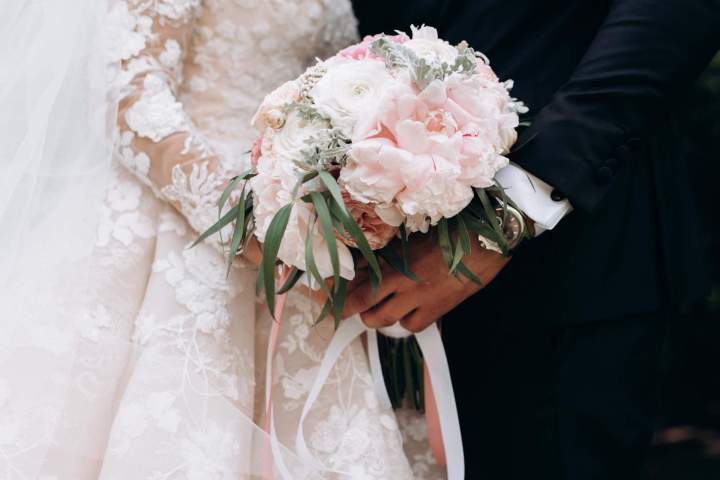 groom bride together are holding wedding pink bouquet 11zon